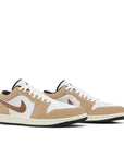 Pair of Jordan 1 Low SE Brown Elephant in brown and white.