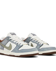 Pair of Nike SB Dunk Low Yuto Horigome in white and light grey