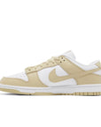 side of Nike Dunk Low team gold in white and gold