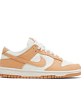 Side of Nike Dunk Low Harvest Moon (W) in white and light brown.