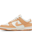 Side of Nike Dunk Low Harvest Moon (W) in white and light brown.