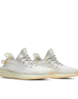 A pair of adidas Yeezy Boost 350 v2 Light sneakers