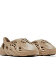 A pair of adidas Yeezy Foam RNNR Mist sneakers