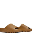 A pair of adidas Yeezy Slide Ochre sneakers