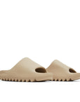 A pair of adidas Yeezy Slide Pure sneakers