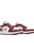 Pair of Jordan 1 Low Bordeaux Grade School in cherrywood red white and grey