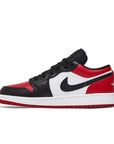 Side of Jordan 1 Low Bred Toe (GS) in red, white and black.