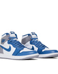 Pair of Jordan 1 Retro High OG True Blue in True Blue, White and Cement Grey.