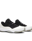 Pair of Jordan 11 Retro Low Reverse Concord in Black and White