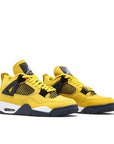 Pair of Jordan 4 Retro Lightning (2021) in Yellow and Dark Blue.