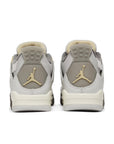 Heels of Jordan 4 Retro SE Craft Photon Dust (GS) in shades of grey