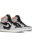A pair of Nike Air Jordan 1 basketball shoes in grey hyper crimson colour