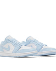 A pair of Nike Air Jordan 1 Low Michael Jordan's in white, blue and aluminium