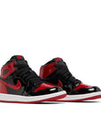 A pair of pre school Nike Air Jordan 1 Retro High OG Patent Bred Off-White University blue childrens shoes in blue and white