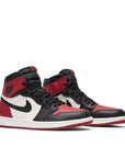 A pair of Nike Air Jordan 1 Retro High Bred Toe Michael Jordans black and red