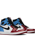 A pair of Nike Air Jordan 1 Retro High OG Fearless UNC Chicago basketball shoes in white and blue