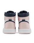Heels of the Nike Air Jordan 1 High Atmosphere basketball shoes are in pink, black and white.