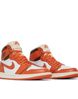 A pair of Air Jordan 1 High OG 'Starfish' is in a white, orange and chocolate brown colourway