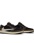 A pair of Nike Air Jordan 1 Retro Low OG SP Travis Scott sneakers in brown, black and white