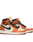 A pair of Nike Air Jordan 1 Retro Reverse Shattered Backboard basketball sneakers in orange and white