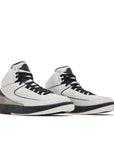 A pair of Nike Air Jordan 2 Retro A Ma Maniere sneakers in white and burgundy