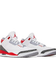 A pair of Nike Jordan Air 3 basketball shoes in a white fire red colour