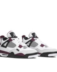 A pair of Nike Air Jordan 4 Retro PSG Paris Saint-Germain basketball sneakers in white, purple and black