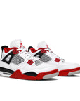 A pair of Nike Air Jordan 4 Retro Fire Red (2020) basketball shoes in white and red