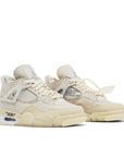 A pair of women's Nike Air Jordan 4 Retro Off-White sail sneakers in cream