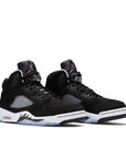 A pair of Nike Air Jordan 5 Retro Moonlight basketball shoes in black and white