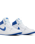 A pair of Nike Air Ship A Ma Maniere Game Royal basketaball sneakers in white and blue