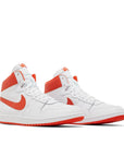 A pair of Nike Air Ship Team Orange basketaball sneakers in white and orange
