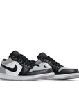 A pair of Nike Air Jordan 1 Low Shadow Toe sneakers in grey and black
