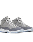 A pair of pre school kids Nike Air Jordan 11 cool grey basketball shoes in grey and white