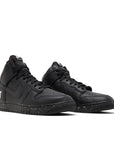 A pair of the Undercover Nike dunk high skating shoes in a black colour