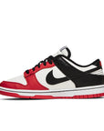 Side of the Nike dunk low basketball shoes in a red black white chicago colour