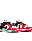 A pair of the Nike dunk low basketball shoes in a red black white chicago colour