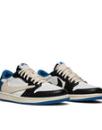 A pair of Nike Dunk Low Fragment x Travis Scott exclusive sneakers in white. black and blue