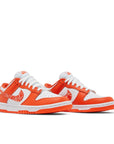 A pair of the womens Nike dunk low in a white orange "orange paisley" colour