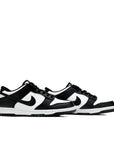 A pair of the older kids version Nike dunk low in a black white "Panda" colour