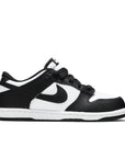 Side of the childrens version of the Nike dunk low in a black white "Panda" colour