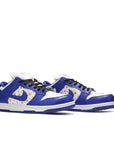 A pair of the Nike dunk supreme low skating shoes in a gold stars white blue hyper royal colour
