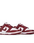 A pair of the Nike dunk lows in a white red "team red" colour