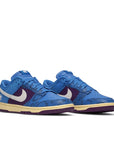 A pair of the Nike dunk low undefeated 5 On It in a blue exotic colour