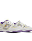 A pair of Nike Dunk Low Union Passport Pack Court Purple sneakers