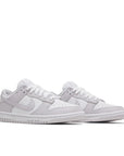 A pair of the womens Nike dunk lows in a white lilac "venice" colour
