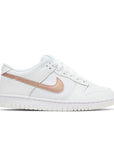 Side of the Nike dunk low grade school sneaker in white and pink