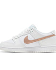 Side of the Nike dunk low grade school sneaker in white and pink