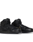 A pair of the Faust Nike sb dunk high skating shoes in a black gold grafitti colour