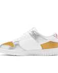 Side of the Nike SB Dunk Low Heirloom womens shoe in white and gold